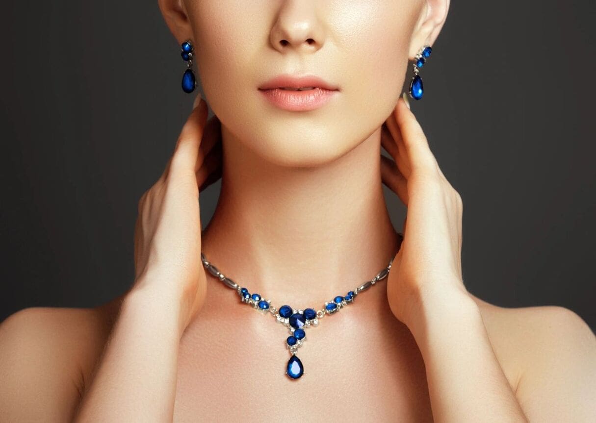 A woman wearing a necklace and earrings.
