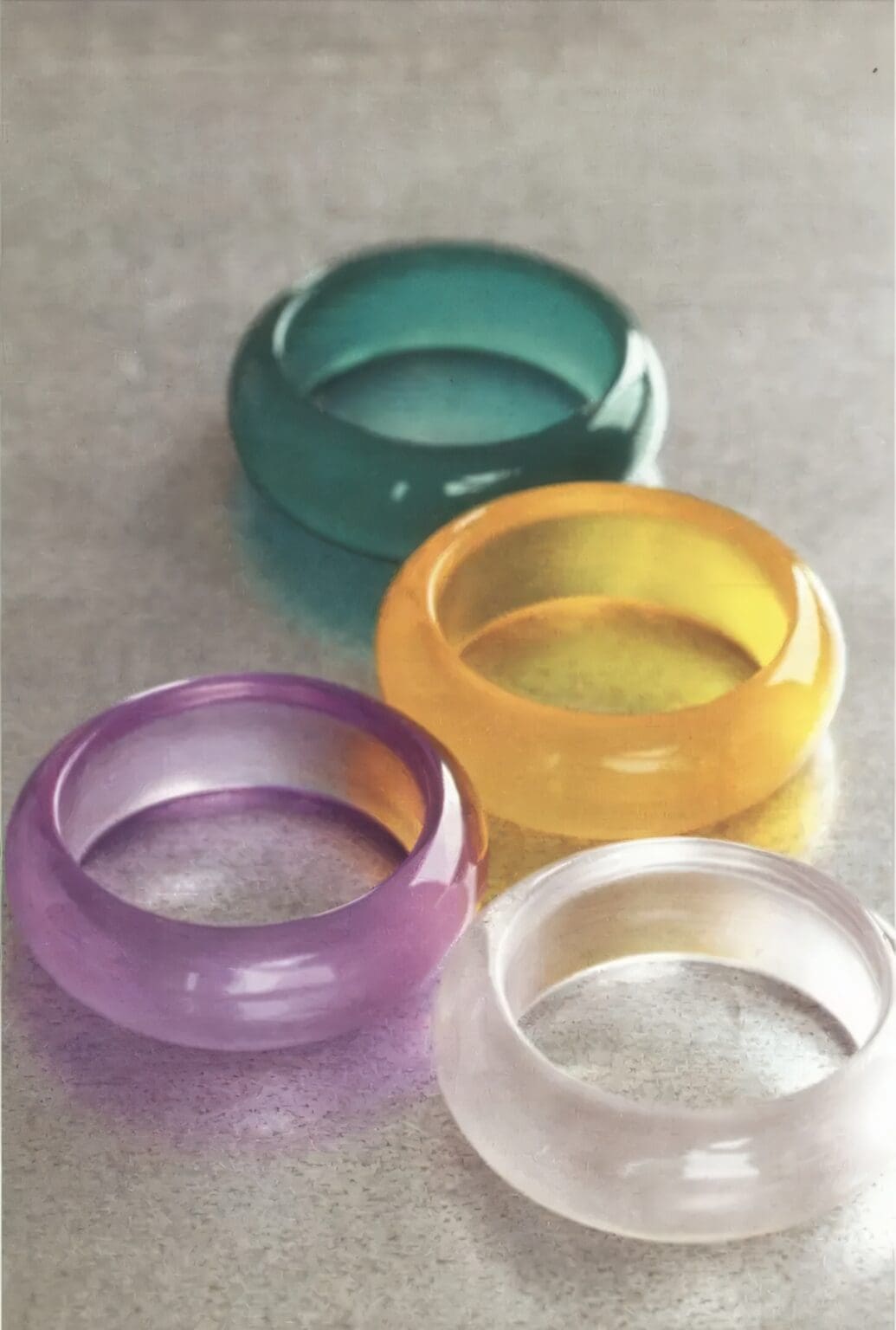 A group of four rings sitting on top of a table.