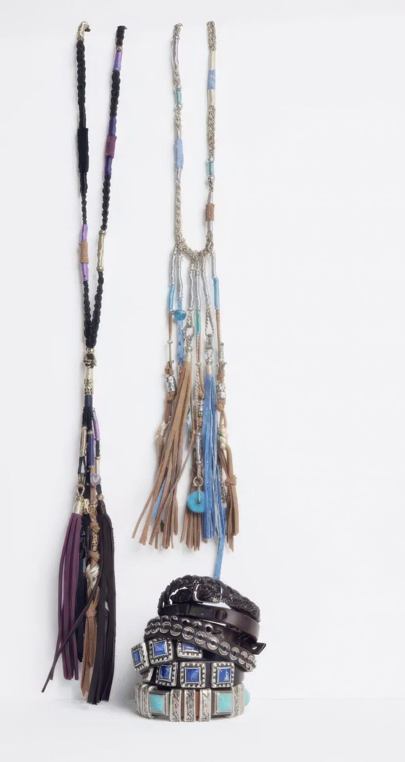 A couple of necklaces hanging on a wall.