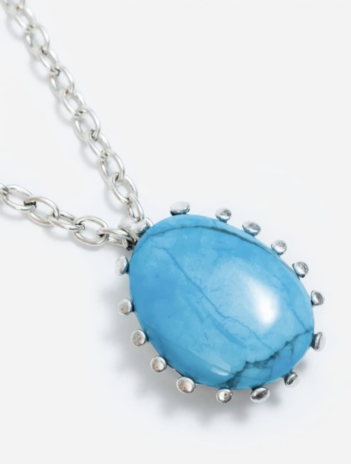 A necklace with a blue stone on it