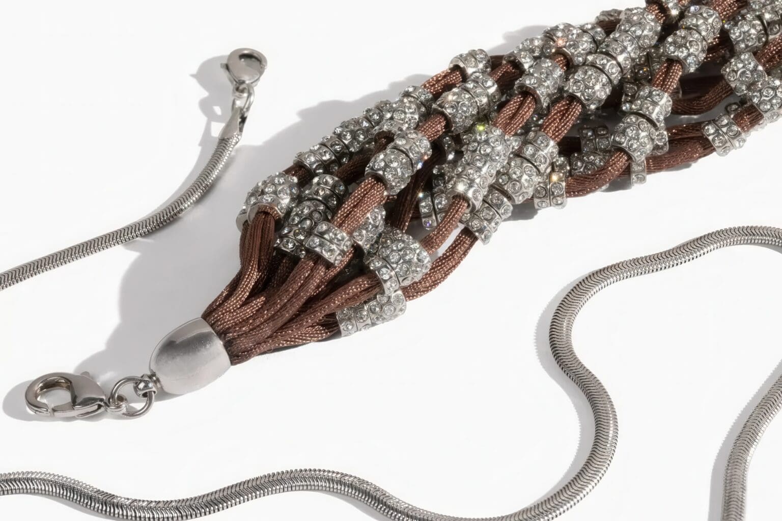 A close up of a necklace with silver beads