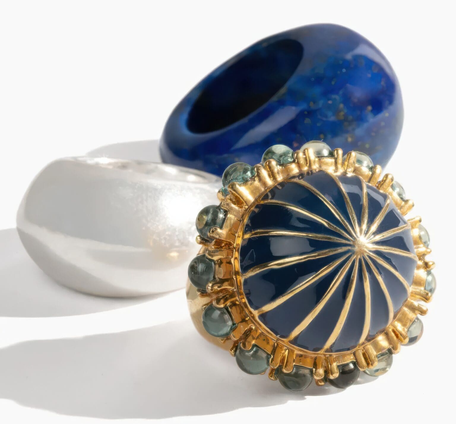 A close up of three different rings on a table