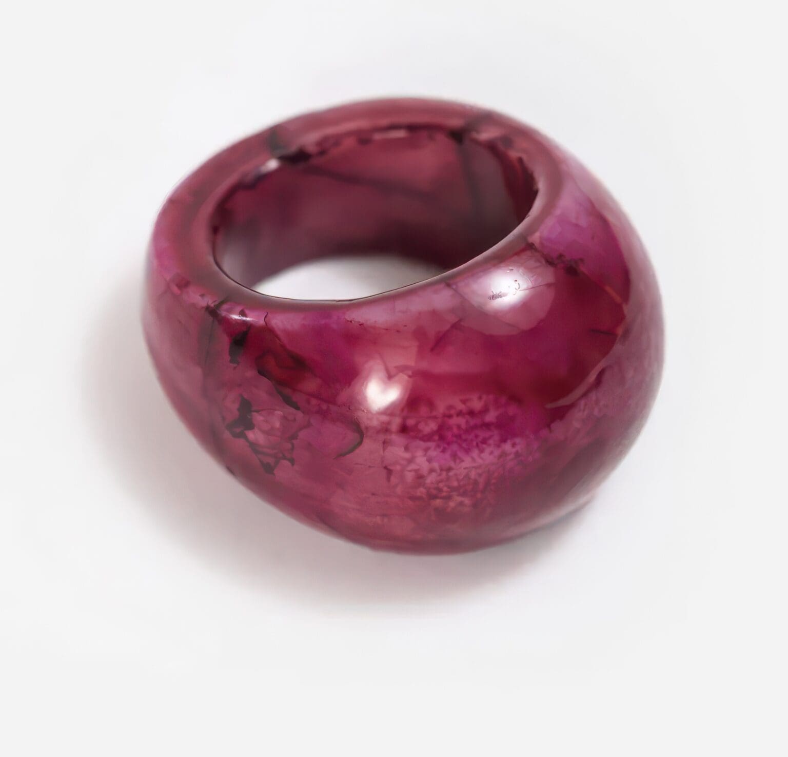 A purple ring is sitting on top of the table.