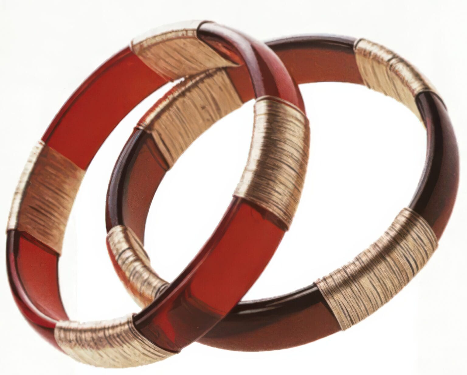 Two bracelets that are red and gold.