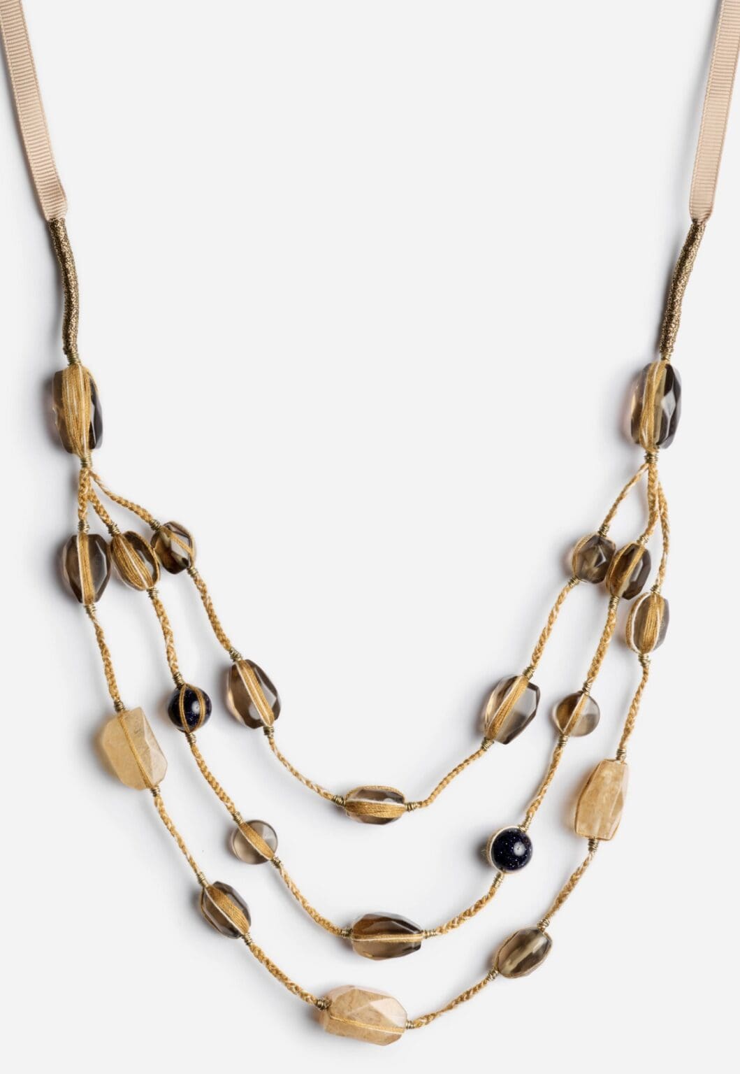 Beaded necklace with layered strands and ribbon.