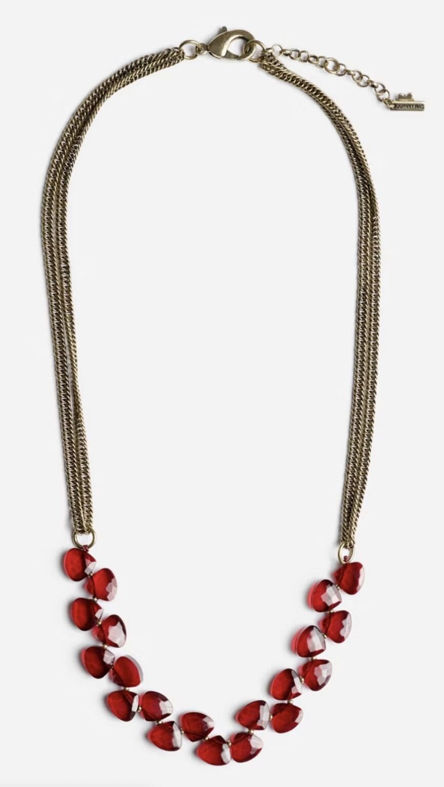 Gold necklace with red heart-shaped beads.