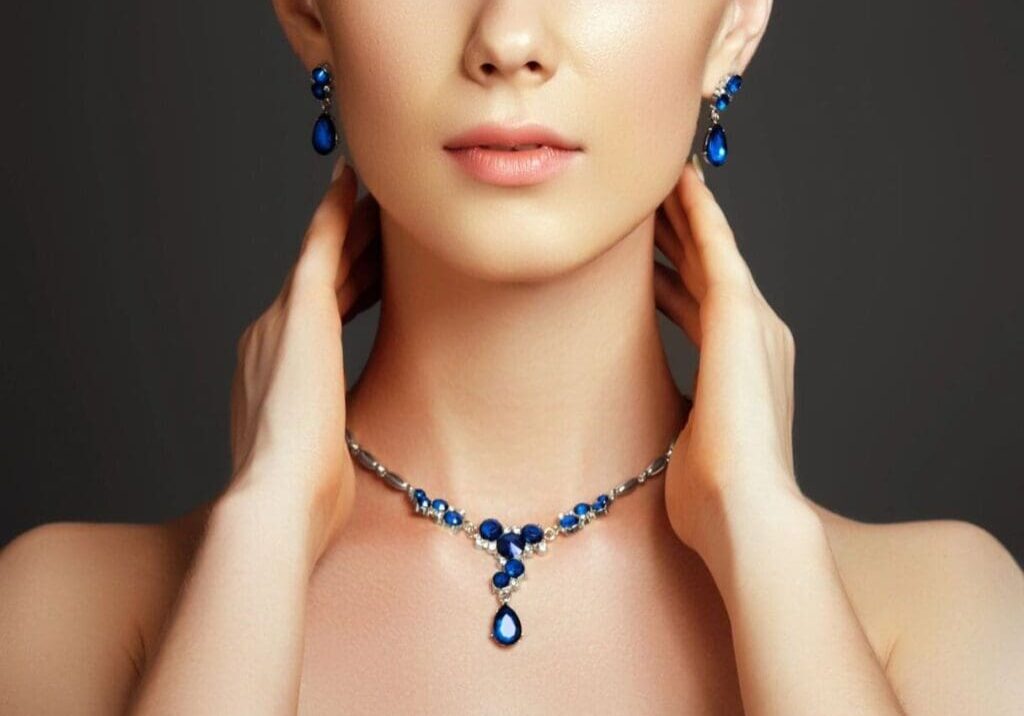 A woman wearing a necklace and earrings.